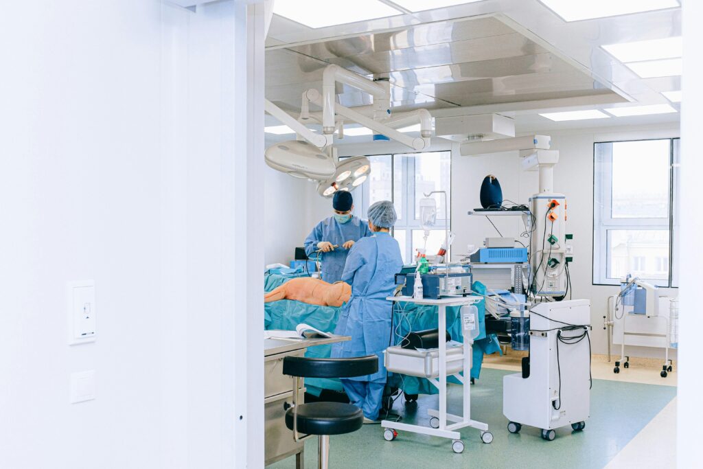 A medical team performs surgery in a well-equipped and sterile operating room.
